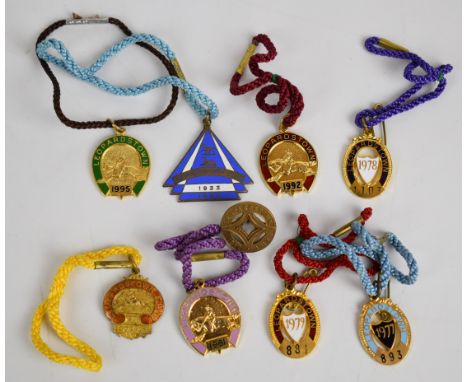 Nine Leopardstown metal and enamel horse racing badges including 1912-1913, 1927-1928 and 1933-1934