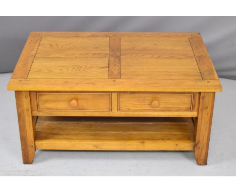 Contemporary oak coffee table with rising / cantilever top and storage under to enable a person to work or eat from a low cha