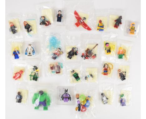 Twenty-seven Lego Marvel and DC minifigures comprising Hulk, Nick Fury, Aquaman, Sinestro, Hawkeye, Green Lantern, Wonder Wom