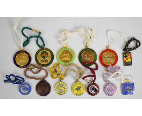 A collection of metal and enamel Irish horse racing badges including Fairyhouse, Dundalk, Limerick and Tipperary examples
