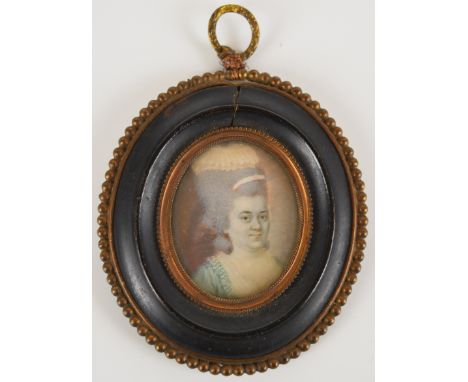 18th century portrait miniature on ivory of a lady, maximum diameter 4cm, in gilt and ebonised frame, overall height 9.5cm, w