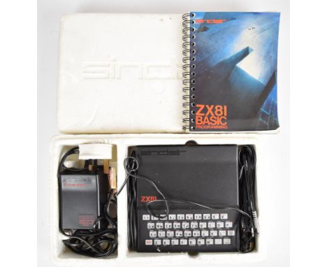 Sinclair ZX81 computer with power supply, cables, instruction manual and polystyrene outer sleeve.