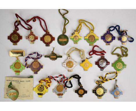 Twenty one Downpatrick Race Club metal and enamel horse racing badges including one 'Steward' example, 1941-2012