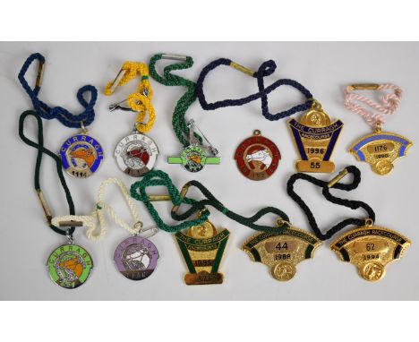 Eleven Curragh Racecourse metal and enamel horse racing badges including one pair, 1953-1996