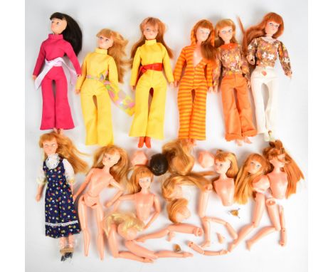 Eight Dollykins Action Girl dolls in vintage outfits, together with a collection of spare heads and limbs.