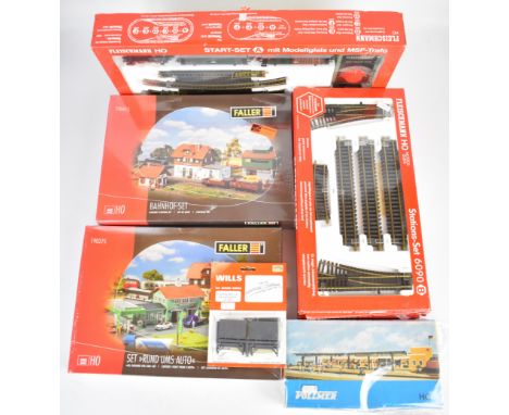 Fleischmann H0 gauge model railway start-set A 6325 together with three additional track sets and related scenery kits.