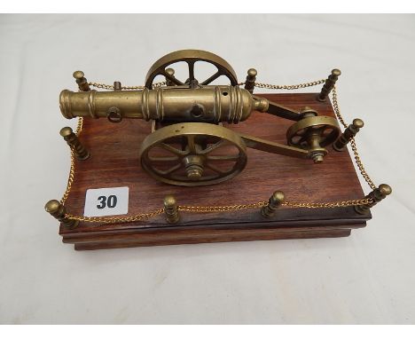 BRASS MODEL OF A CANON MOUNTED ON A PLINTH