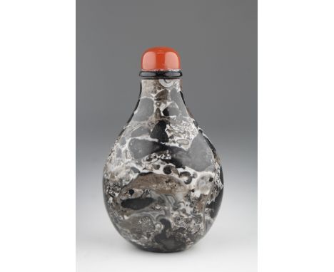 Chinese Fossiliferous Limestone Snuff Bottle. 19th/20th century. Of Pear-form, the creamy grey matrix suffused with black chi