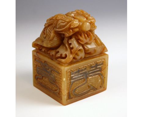 A large Chinese soapstone seal, 20th century, carved with two 'Chilong' beasts above Kaishu calligraphy, 11.5cm high, with bo