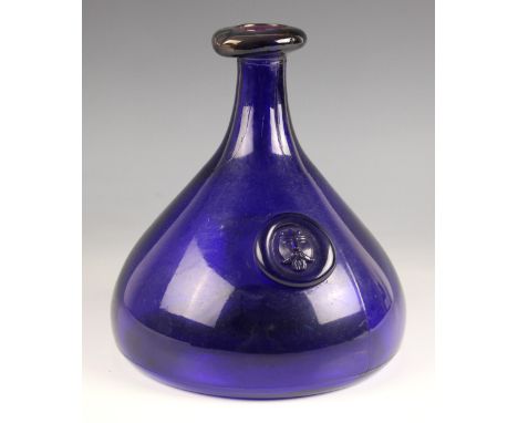 A Holmegaard glass carafe, 20th century, in the Ole Winther design, the cobalt body with Viking face seal to the front, 20.5c