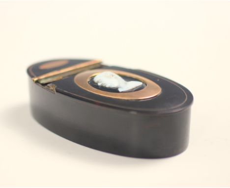 A 19th century tortoiseshell and gold mounted snuff box, the oval box with half hinged cover inlayed with cameo depicting gen