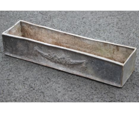 A lead trough planter, of rectangular form, moulded in relief with foliate swags to the side panels, 16cm H x 79cm W x 22cm D