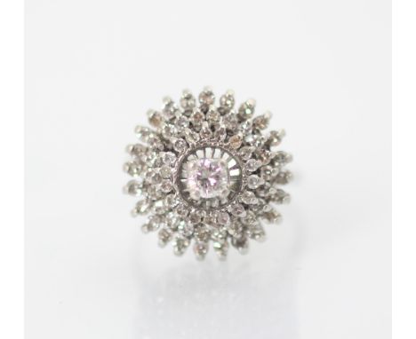 A 1960’s diamond set dress ring, the central round cut diamond within triple raised borders set with further smaller round cu
