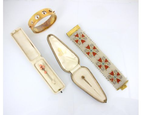 A selection of jewellery, including a beadwork bracelet, possibly French, the four repeating detailed motif with gilt metal b