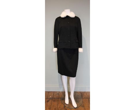 A 1960s skirt suit, of black wool face cloth, labelled 'Sheen N tailor made', the short jacket with patch pockets, centre fro