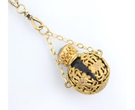 An early 20th century perfume pendant, the globular shaped vinaigrette with overlay scroll decoration with enamel red detail,