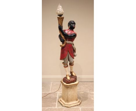 A painted composite figural standard lamp, early 20th century, modelled as a blackamoor wearing a red robe and britches, hold