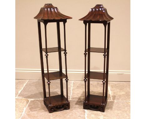 A pair of Chinese Chippendale style mahogany wall shelves, 20th century, each with a pagoda style canopy over three shelves u