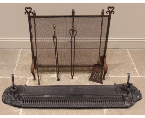 A 19th century iron fire kerb, the pierced front gallery extending to cast scrolling foliate detail and a pair of conforming 