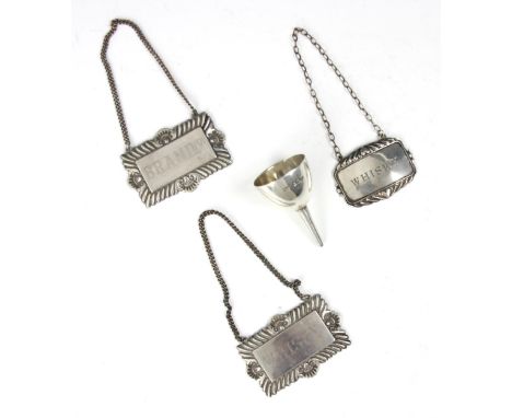 A silver 'Whisky' decanter label, Crisford &amp; Norris, Birmingham 1978, with two further white metal decanter labels, and a