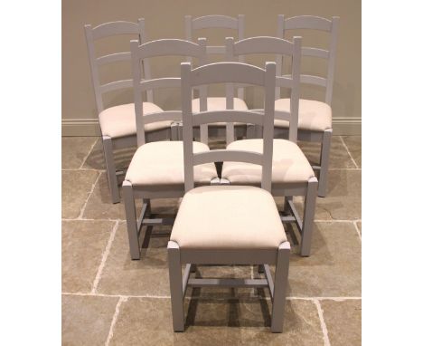 A set of six contemporary painted ladder back chairs, each with three rungs over an upholstered seat, upon legs of square sec