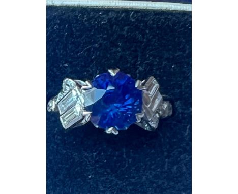 An Art Deco certified Sri Lankan sapphire and diamond ring, the round cut sapphire within white metal claw set setting edge, 