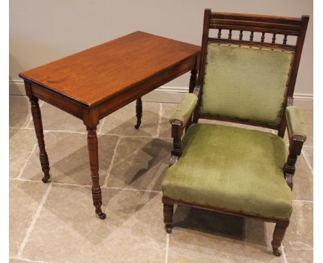 An Edwardian walnut side/occasional table, the rectangular top upon ring turned and incised legs extending to ceramic castors