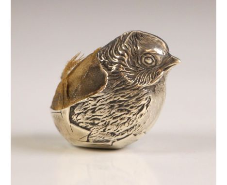 An Edwardian silver novelty pin cushion, Sampson Mordan Co, Chester 1907, modelled as a chick with chased detailing and pin c