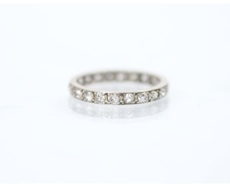 An early 20th century diamond full eternity ring, the twenty two mixed cut diamonds set in white metal mount, total diamond w