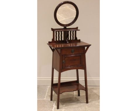 An Arts and Crafts walnut shaving stand, early 20th century, the adjustable circular mirror, over a bracket shelf, wavy galle