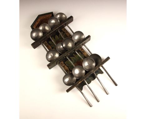 A Northern European folk art painted pine spoon rack, 19th century, the tall back decorated with naively painted flora and fo