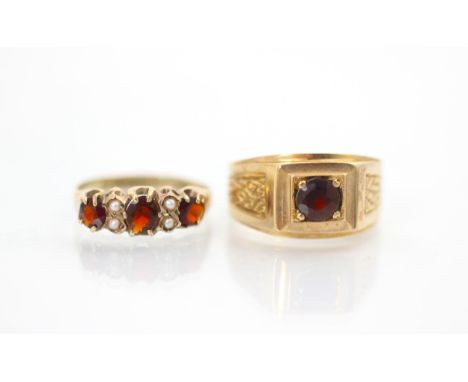 A late 19th century garnet and seed pearl ring, the three graduated oval cut garnets with two seed pearls in between, set to 