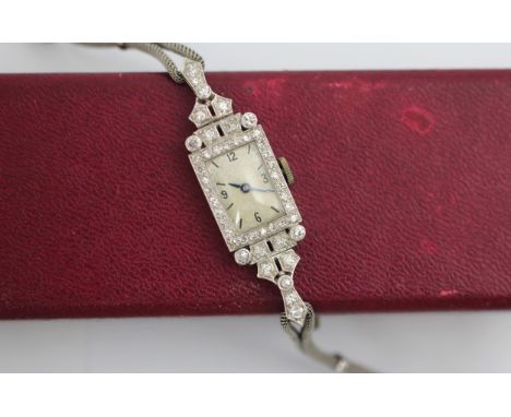 A 20th century diamond set cocktail watch, retailed by Harrods, the rectangular face with Arabic and baton numerals, set to a