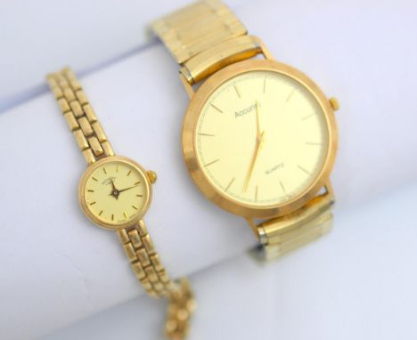 A yellow metal ‘Accurist’ wristwatch, the circular cream dial with baton markers, set to plain polished case and plated expan