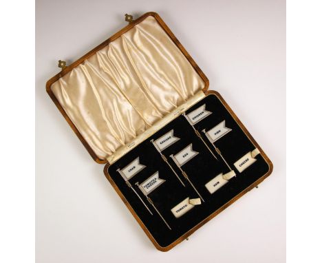 A cased set of six sterling silver sandwich flags or labels by Amnora, early 20th century, the six flags with interchangeable