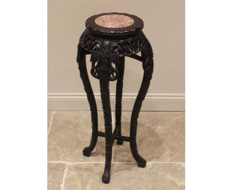 A Chinese carved hardwood and rouge marble jardinière stand, early 20th century, the circular top inset with a marble plaque 