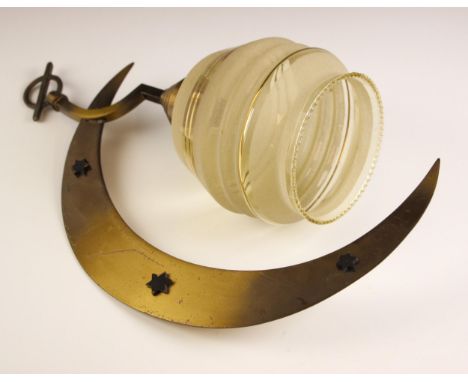 A 1940s brass and glass light fitting, modelled as a crescent moon with applied stars, suspending a shade with gilt banding a