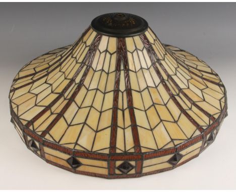 A Tiffany style stained glass ceiling light, of swept circular form with an all over geometric design in amber and taupe glas