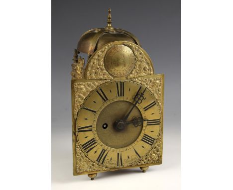 An 18th century brass lantern clock, the 11cm overhead saucer bell above the 15cm break arch brass dial applied with Roman nu