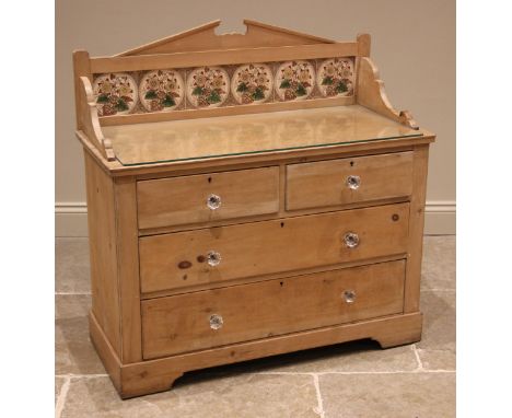 A Victorian pine wash stand, the tile back with an architectural pediment above an arrangement of two short and two long draw