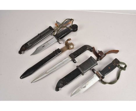 Three AK47 bayonets and scabbards, two with similar blade, one with hand painted number 102, and stamped K100, the other with