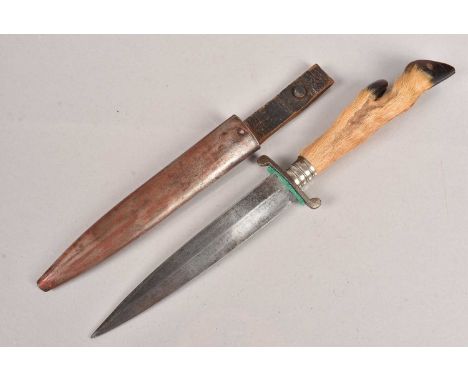 A WWI German Boot knife, having a diamond shaped, single edge blade, 15.5cm long blade, having deer foot grip, complete with 