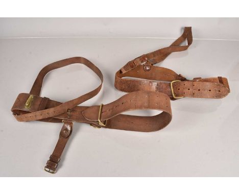 Two named Sam Browne belts, one stamped RFC by Junior Army & Navy Stores Limited, named in ink 'Lt G.A. Rinders', the other '