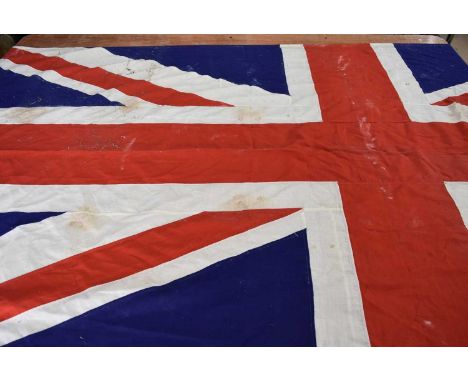 A large vintage Army & Navy Stores Union Flag, approx. 275cm x 132cm, with stains and minor damage