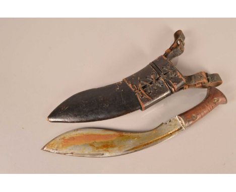 A WWII Era Kukri knife, having 28cm long blade, with wooden handle, complete with scabbard and skinning knives