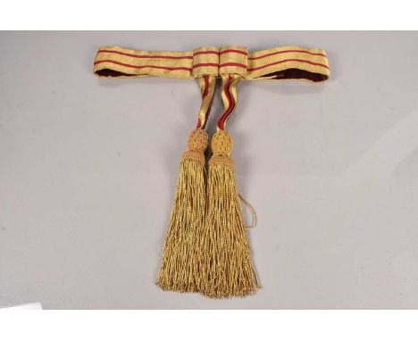 A General Officer's Ceremonial Waist Sash, in gilt with two red stripes, with gilt and braided tassels, with makers label Hob