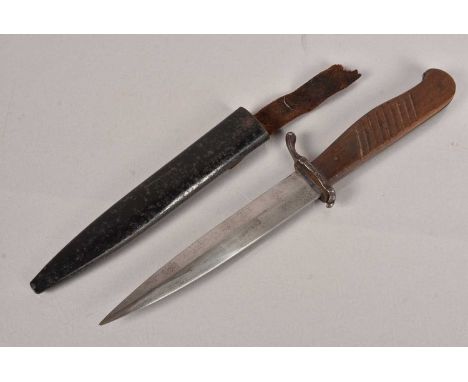 A WWI German Boot knife, having a 14.5cm long double edged tapering blade, in the FS style, complete with scabbard, possibly 