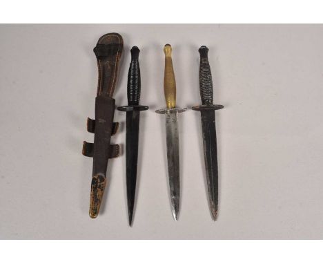 A WWII B2 Fairbairn Sykes Fighting knife, together with  two post war Fairbairn Sykes Fighting knives, one marked with a broa