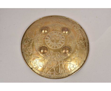 A Middle Eastern Brass circular shield, with hunting decoration, with large cats hunting elephants and other large animal, su