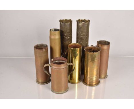 An assortment of trench art shells, to include a pair with fluted middles, one with applied handles and more, all WWI period 